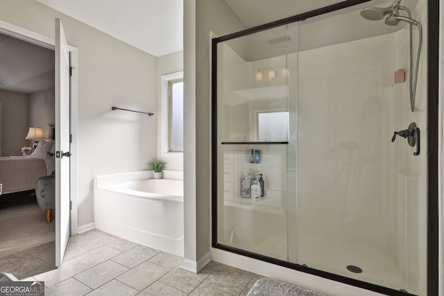 bathroom featuring tile patterned floors and separate shower and tub