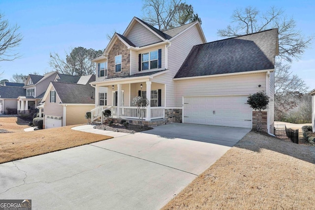 view of front of property featuring covered porch and a garage