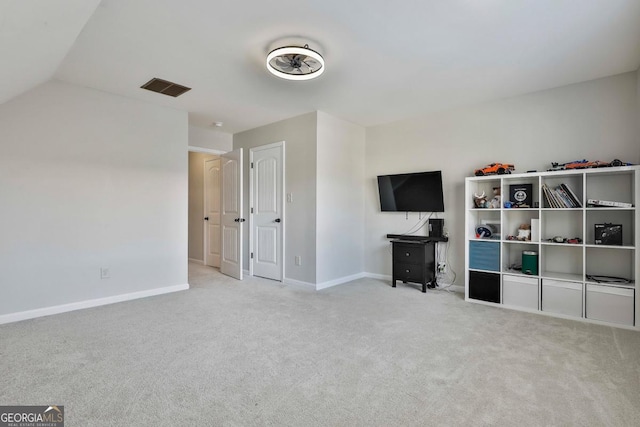 interior space featuring light colored carpet and lofted ceiling