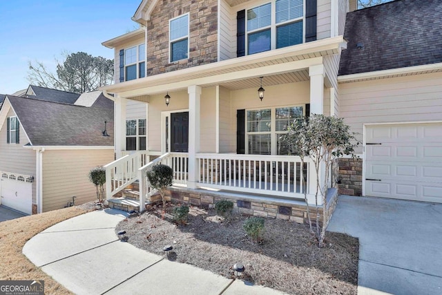 view of front facade featuring a porch and a garage