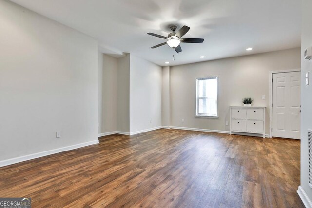 unfurnished bedroom with ceiling fan and dark hardwood / wood-style floors