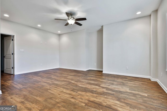 empty room with dark hardwood / wood-style floors and ceiling fan