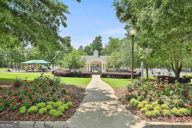 view of community with a yard and a playground