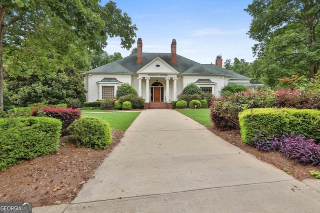 greek revival house with a front yard