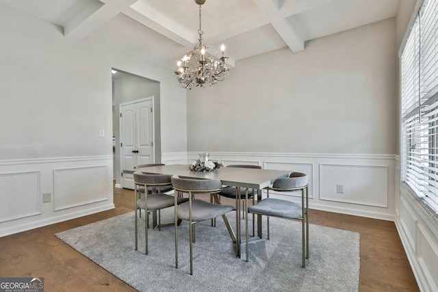 dining area featuring beam ceiling, coffered ceiling, dark wood-type flooring, and a notable chandelier