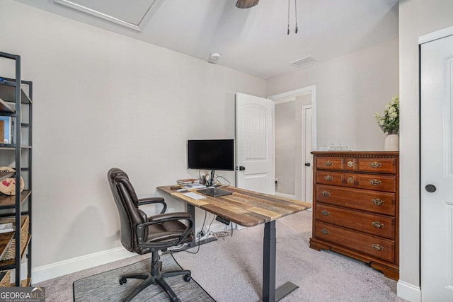 carpeted office featuring ceiling fan