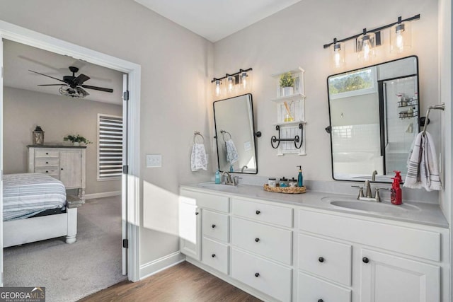 bathroom with hardwood / wood-style floors, vanity, and ceiling fan