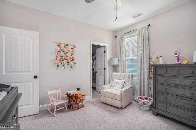 interior space featuring light colored carpet and ceiling fan