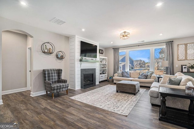 living room featuring a fireplace and dark hardwood / wood-style flooring