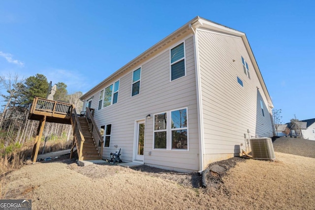 back of property with a wooden deck and central air condition unit