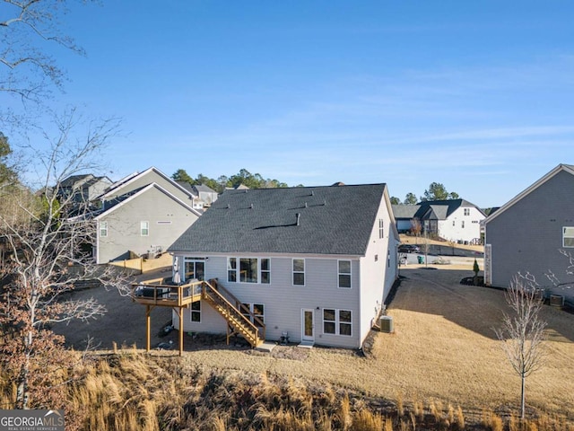 rear view of property with cooling unit and a wooden deck