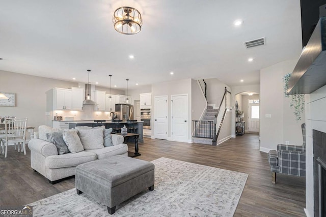 living room featuring a chandelier and dark hardwood / wood-style floors