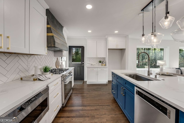 kitchen featuring sink, white cabinets, appliances with stainless steel finishes, and blue cabinetry