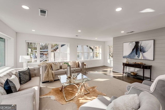 living room with wood walls and hardwood / wood-style flooring