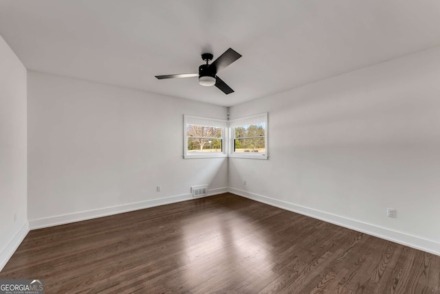 spare room with ceiling fan and dark hardwood / wood-style floors