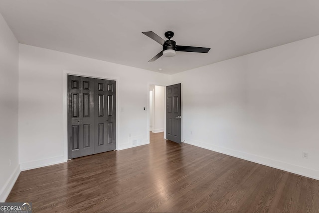 unfurnished room with ceiling fan and dark hardwood / wood-style flooring