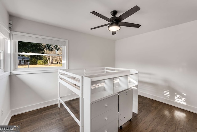 unfurnished bedroom featuring ceiling fan and dark wood-type flooring