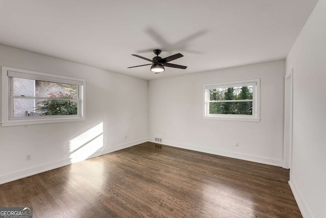 spare room with ceiling fan and dark hardwood / wood-style flooring