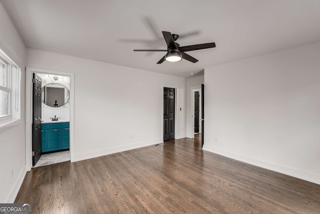 unfurnished room featuring dark wood-type flooring, sink, and ceiling fan