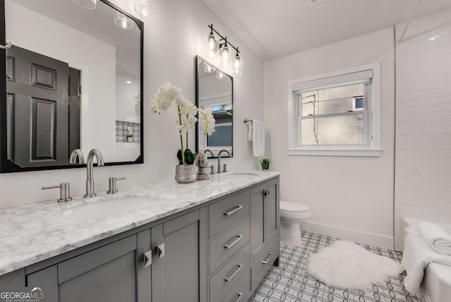 bathroom with toilet, tile patterned flooring, and vanity