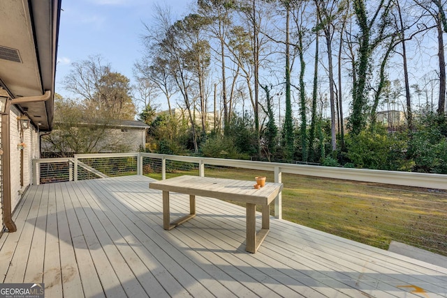 wooden terrace with a yard