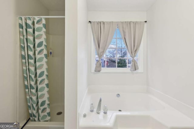 bathroom featuring shower with separate bathtub