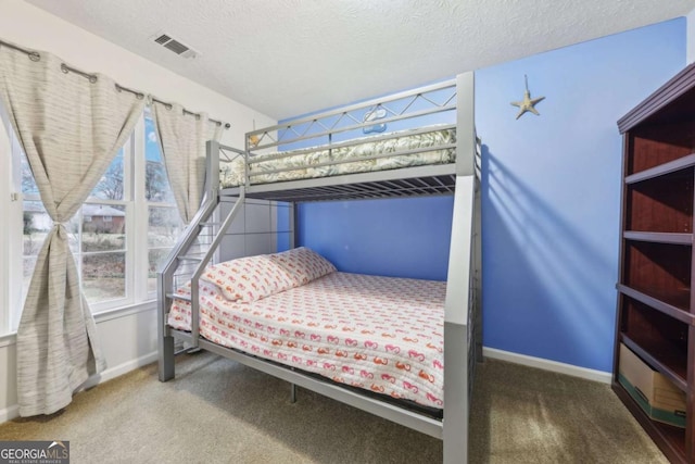 bedroom featuring carpet floors and a textured ceiling