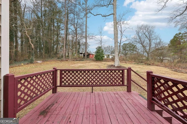 wooden deck featuring a yard