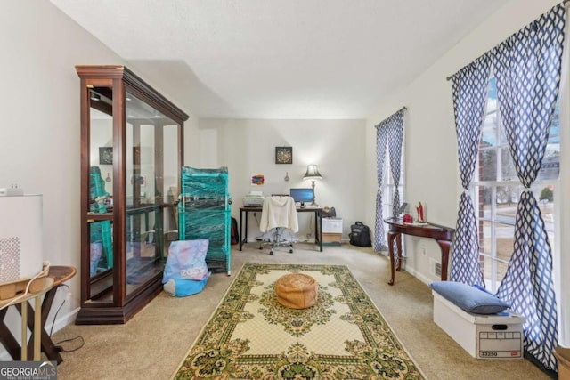 living area with plenty of natural light and light colored carpet