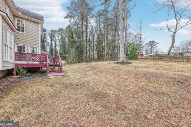 view of yard with a wooden deck