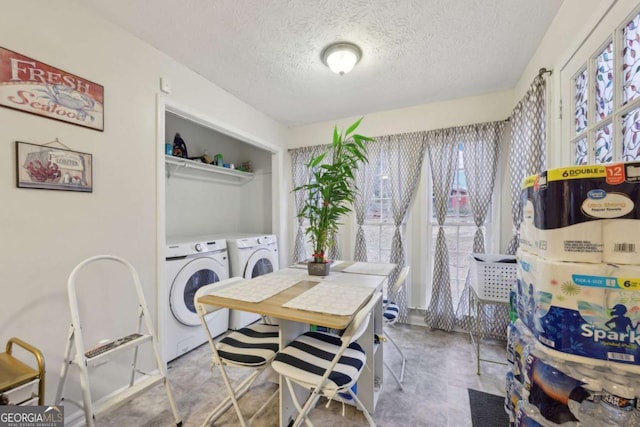 dining space featuring a textured ceiling and washing machine and clothes dryer