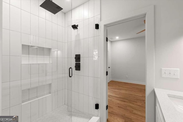 bathroom featuring hardwood / wood-style floors, vanity, and an enclosed shower