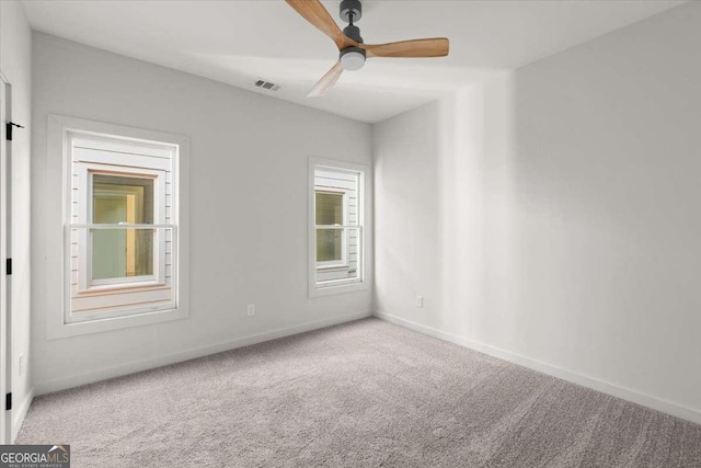 spare room featuring carpet and ceiling fan