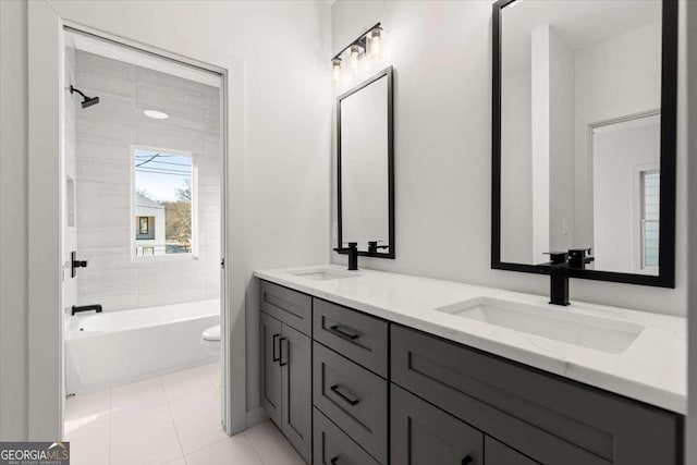 full bathroom with tile patterned flooring, vanity, toilet, and tiled shower / bath