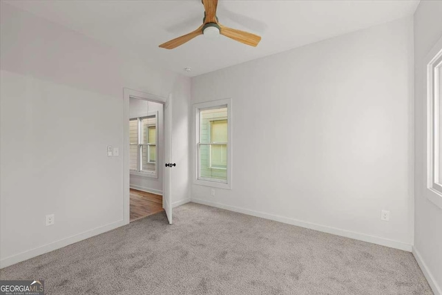 unfurnished bedroom featuring ceiling fan and light colored carpet