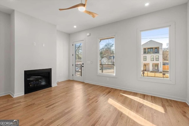 unfurnished living room featuring light wood-type flooring and ceiling fan