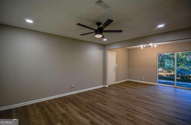 empty room with dark hardwood / wood-style flooring and ceiling fan