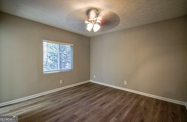 unfurnished room with ceiling fan, dark hardwood / wood-style floors, and a textured ceiling