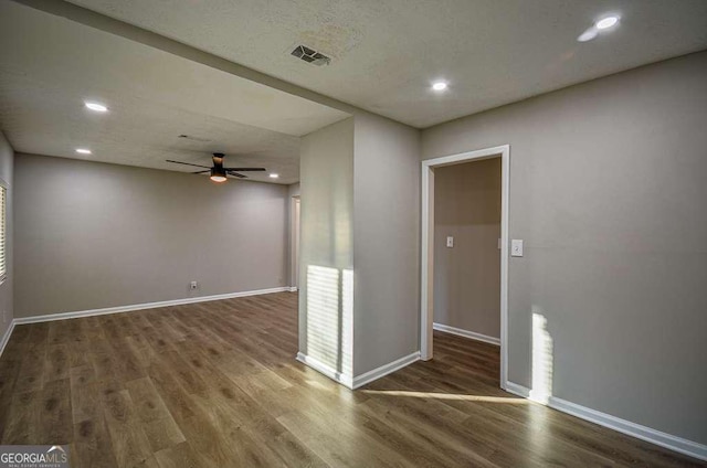 spare room featuring ceiling fan and dark hardwood / wood-style flooring