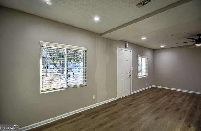 foyer featuring a textured ceiling, dark hardwood / wood-style flooring, and ceiling fan