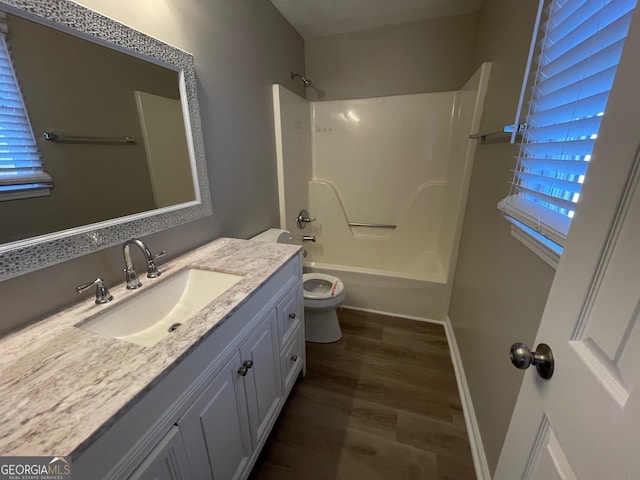 full bathroom featuring toilet, vanity, tub / shower combination, and hardwood / wood-style flooring