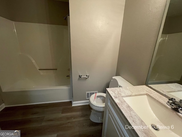 full bathroom featuring vanity, toilet, wood-type flooring, and washtub / shower combination