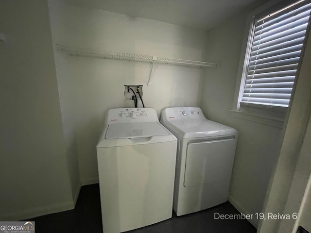 laundry area with independent washer and dryer and a healthy amount of sunlight