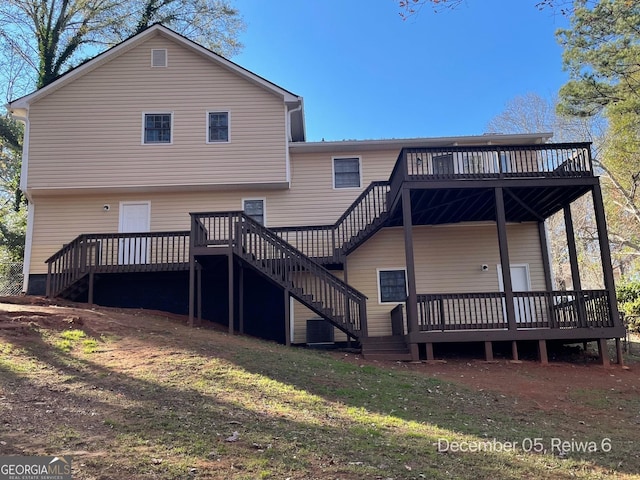 back of house with a yard and a wooden deck