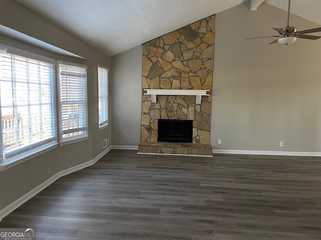 unfurnished living room featuring dark wood-type flooring, ceiling fan, a fireplace, and lofted ceiling with beams