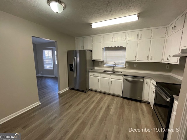 kitchen with sink, white cabinets, and stainless steel appliances