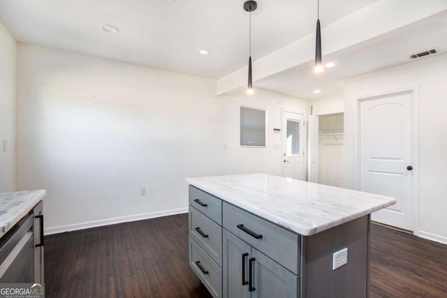 kitchen featuring hanging light fixtures, beam ceiling, dark hardwood / wood-style flooring, a kitchen island, and light stone counters