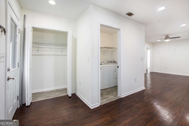 unfurnished bedroom with separate washer and dryer, ceiling fan, and dark wood-type flooring