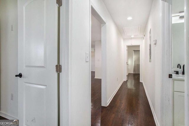 hallway with dark hardwood / wood-style flooring