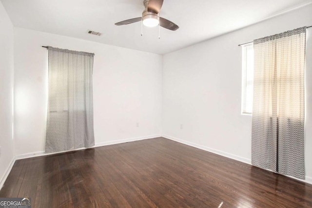 spare room with ceiling fan and dark hardwood / wood-style flooring